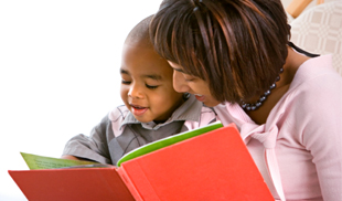 Mother reading book to child