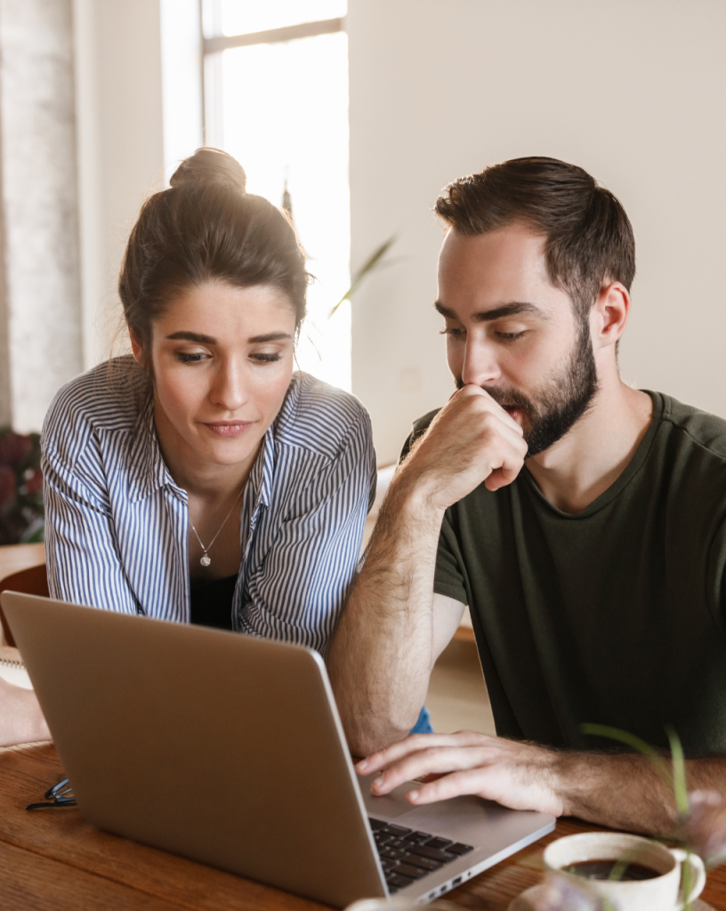 Young couple looking at a computer screen together