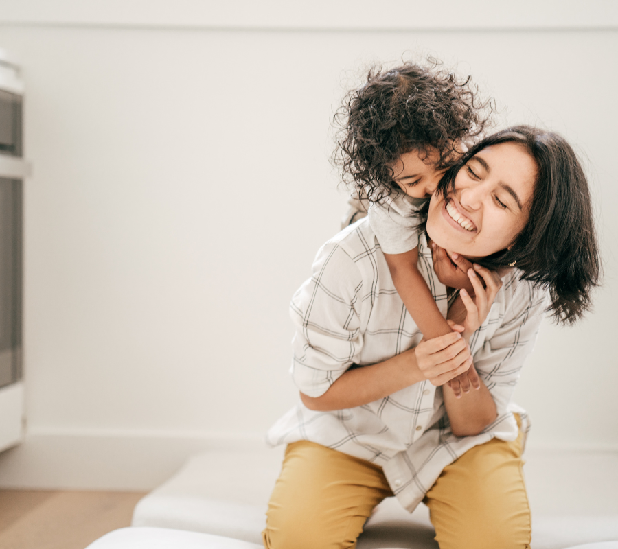 small child hugging mom